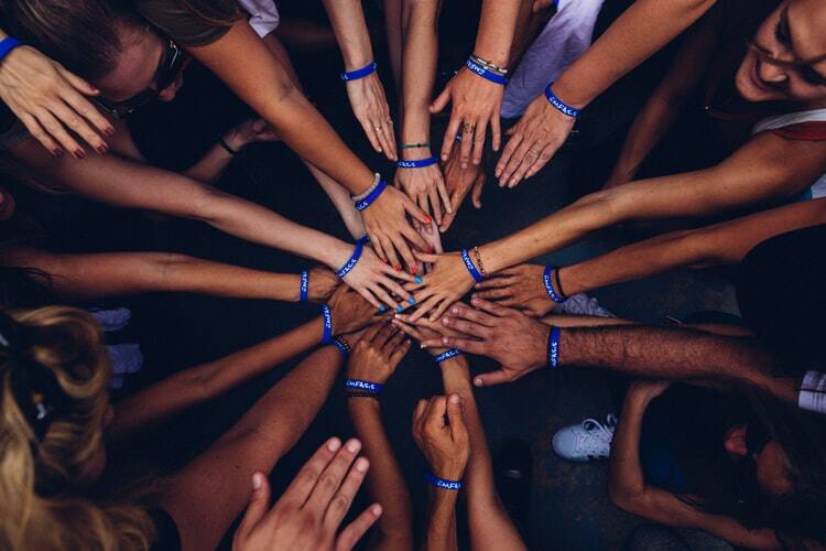 a group of hands connecting with each other..