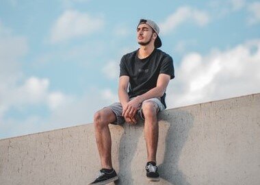 A man sitting on a ledge..
